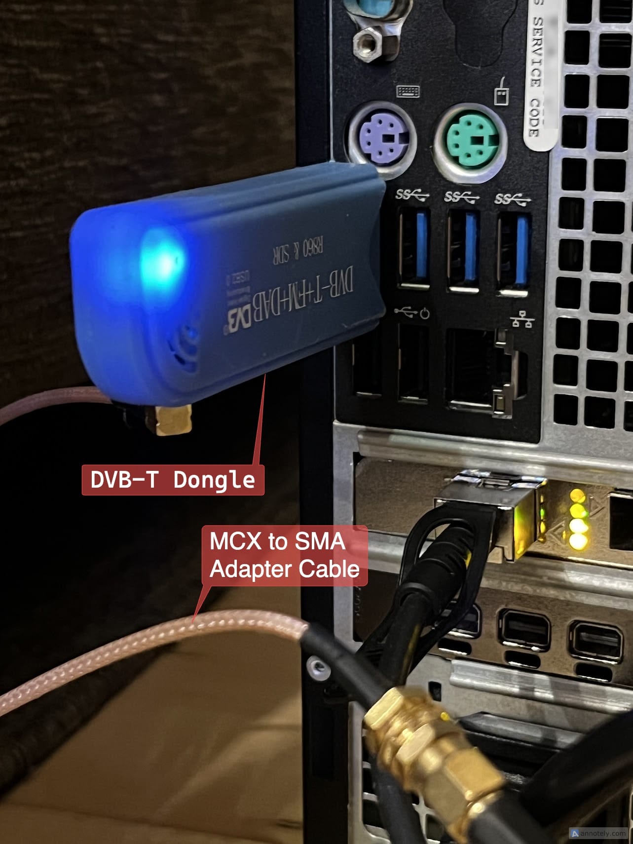My RTL-SDR setup, consisting of a DVB-T tuner plugged into a Dell Precision Tower 3420. An antenna is connected using the help of an MCX to SMA adapter cable.